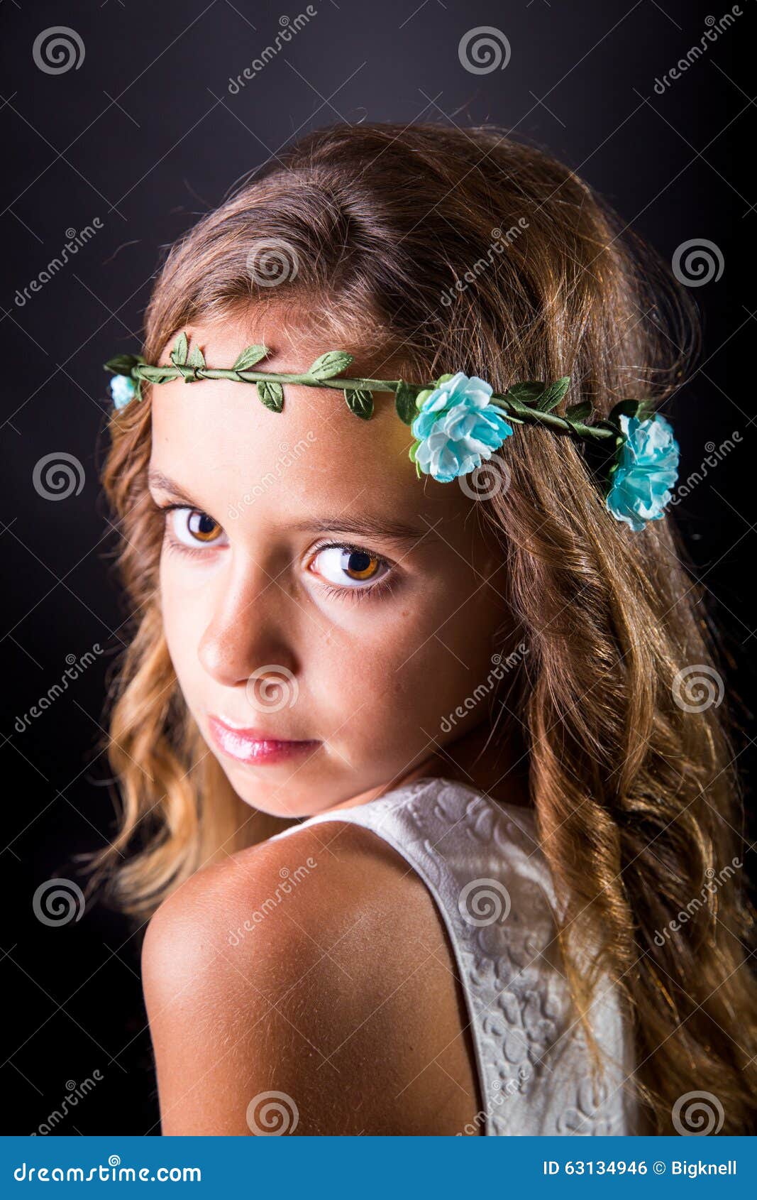 closeup of a young girl with flower tiara and sober look
