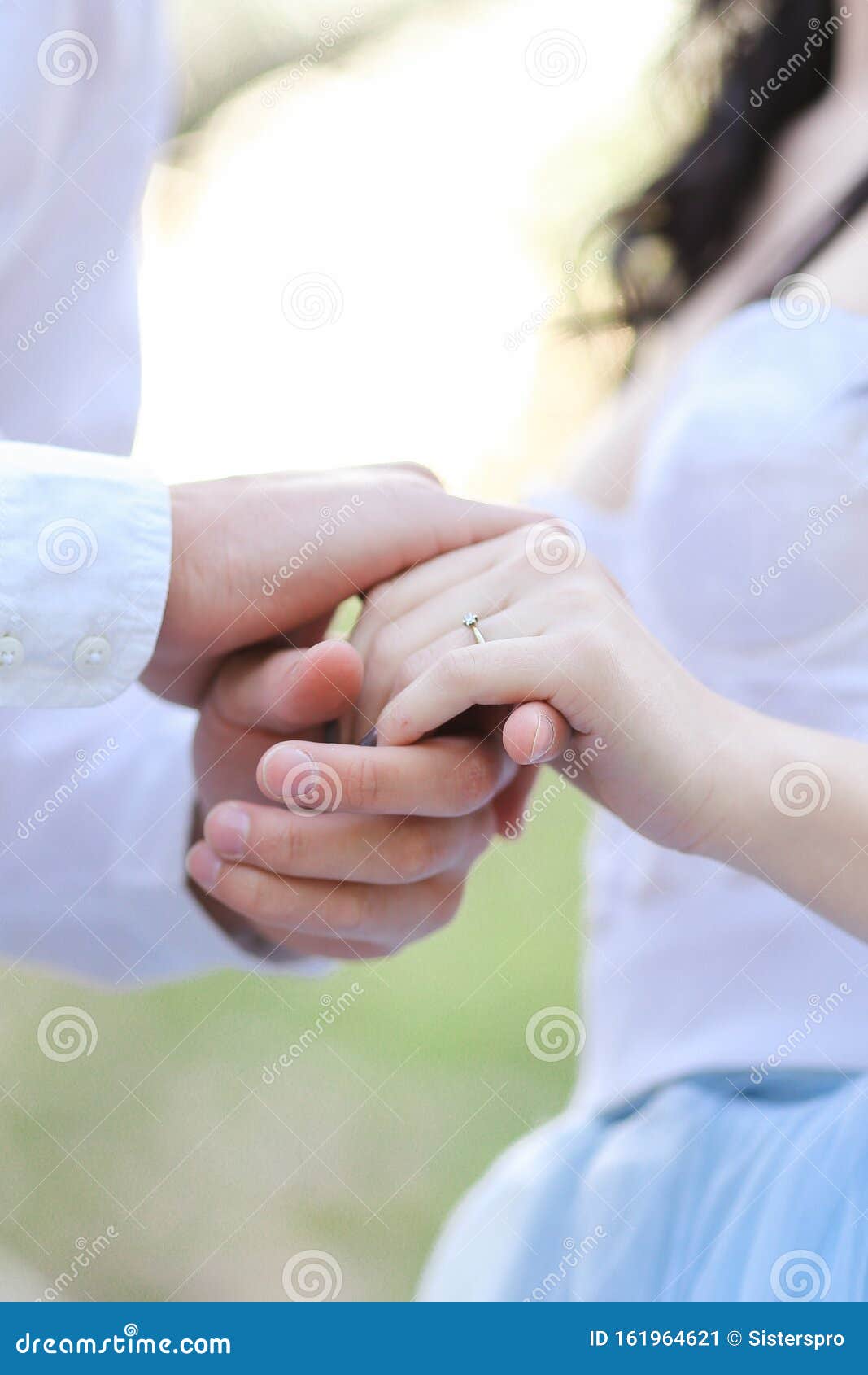 closeup young male and female hands holding each other.