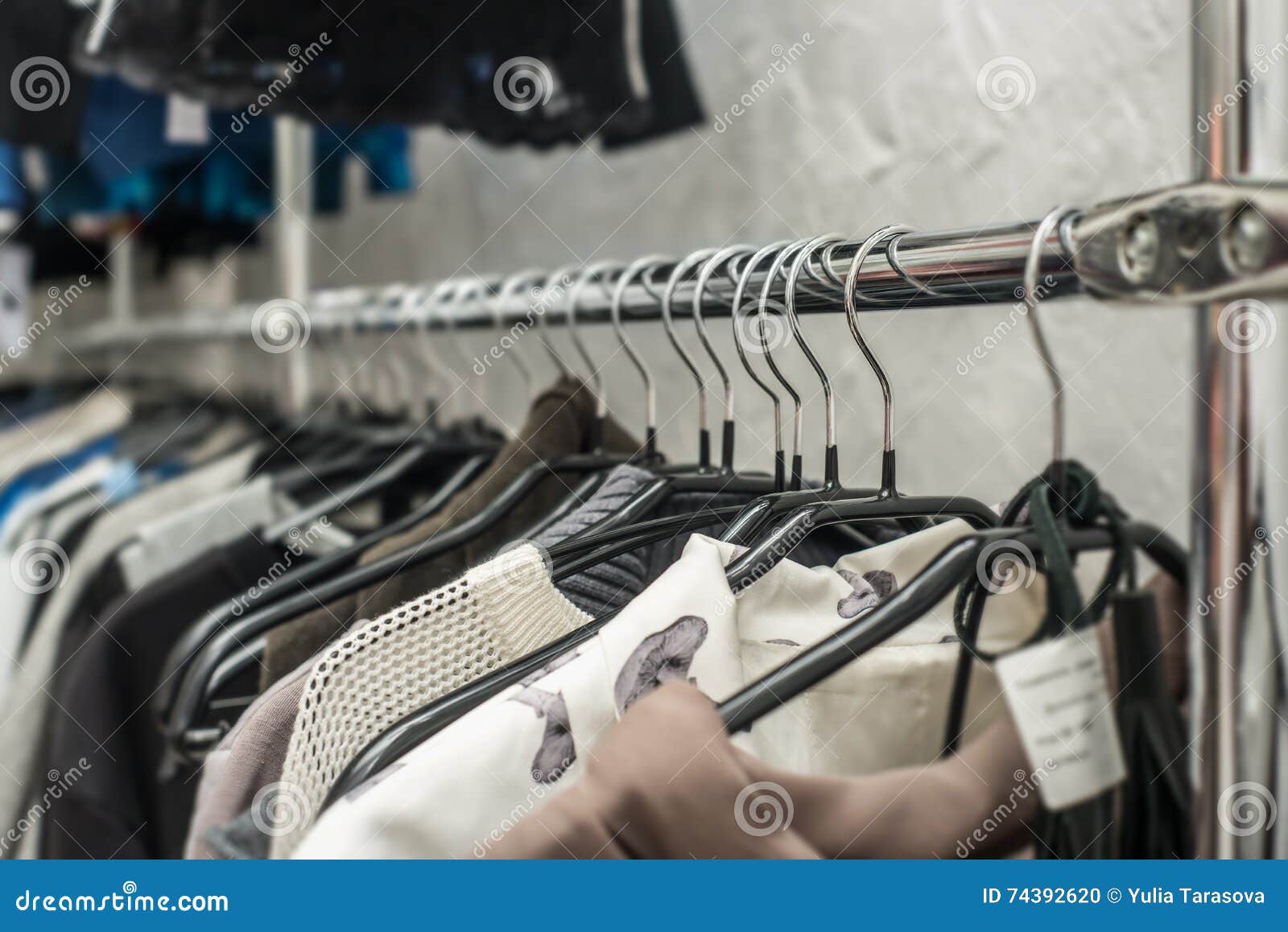 Clothes Hang on a Shelf in a Clothes Store Stock Photo - Image of dress ...