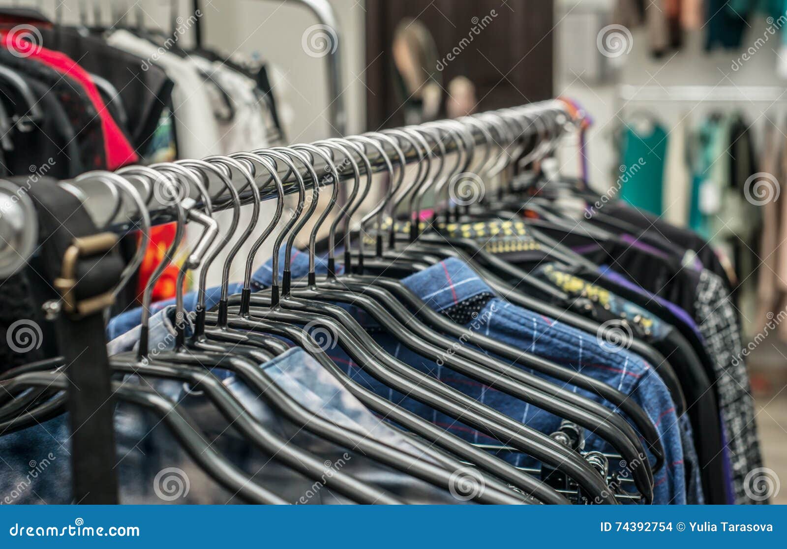 Clothes Hang on a Shelf in a Clothes Store Stock Photo - Image of ...