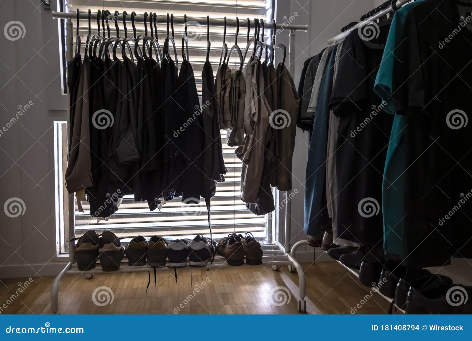 Clothes on the Hangers and Shoes Inside the Dressing Room Stock Photo