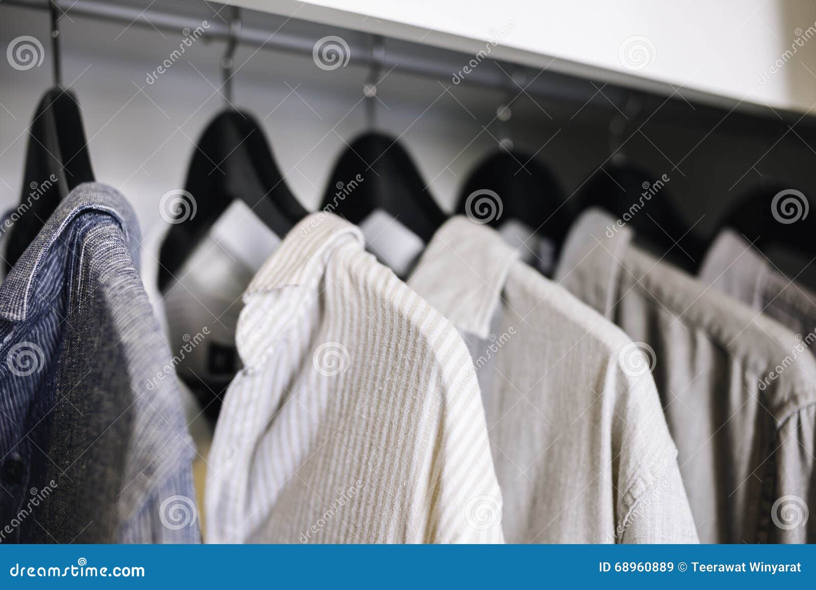 clothes hanging in closet shop fashion display