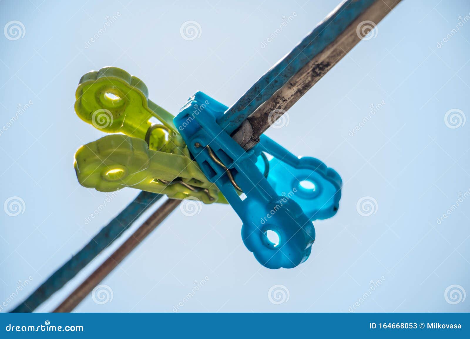Clothes Pegs Hanging on a Cord Against the Blue Sky. Stock Image ...