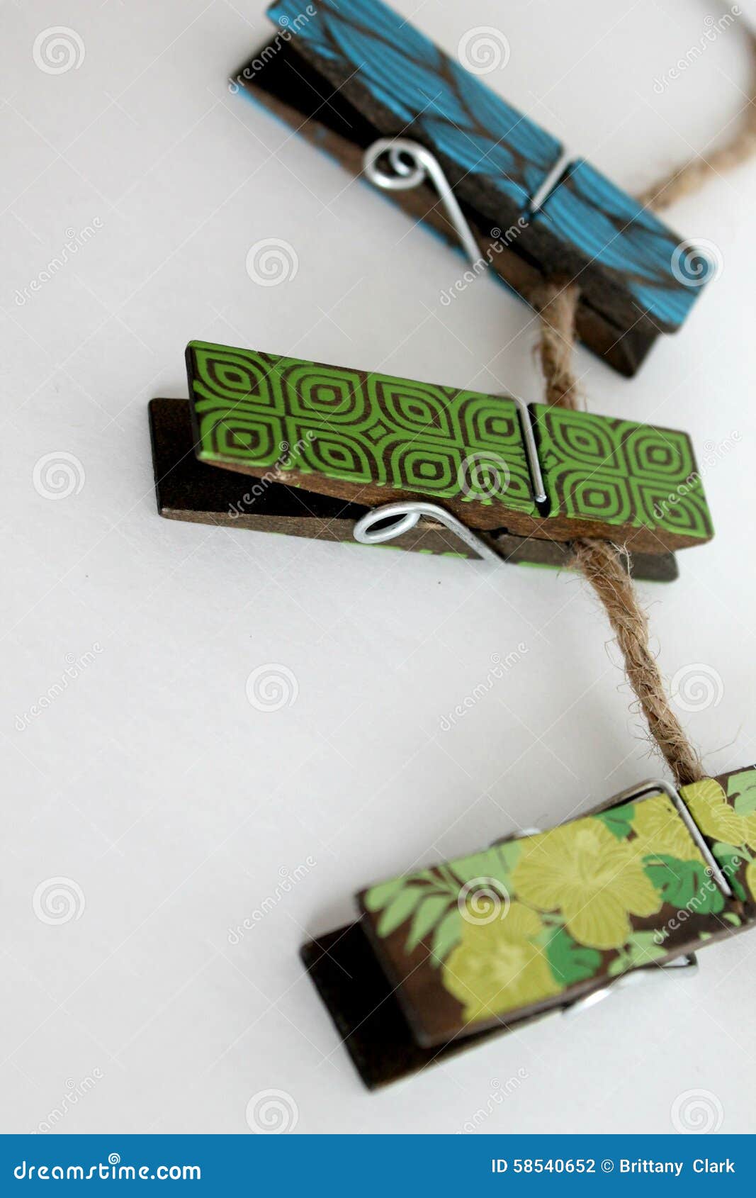 Decorative Wooden Clothes Pins with Patterns Hanging on Twine Stock