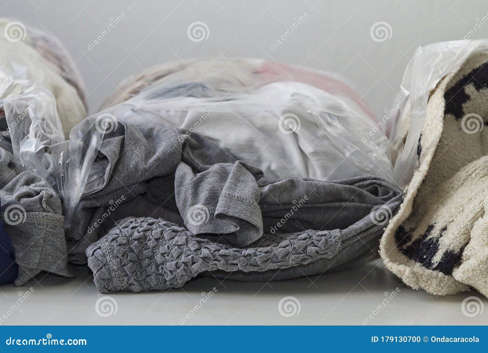 Clothes in plastic bags stock photo. Image of fabric 179130700