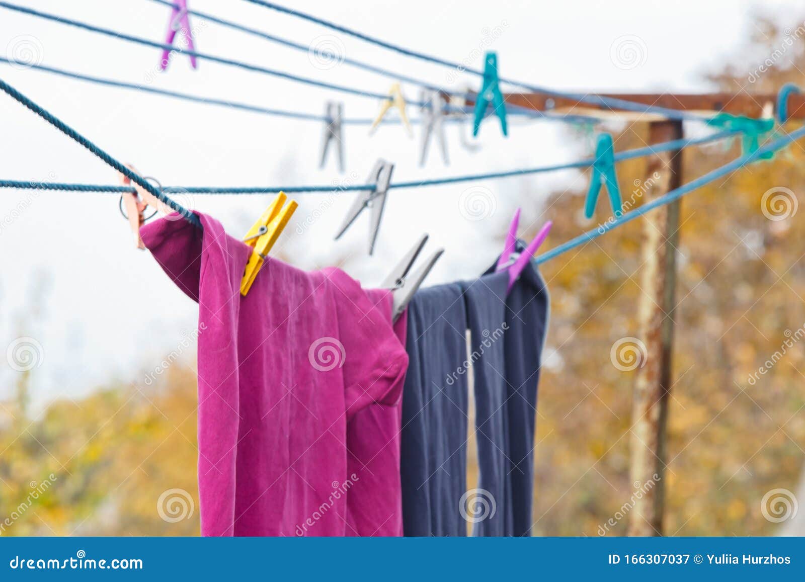 A Clothespin Hangs on the Washing Line. a Rope with Clean Linen