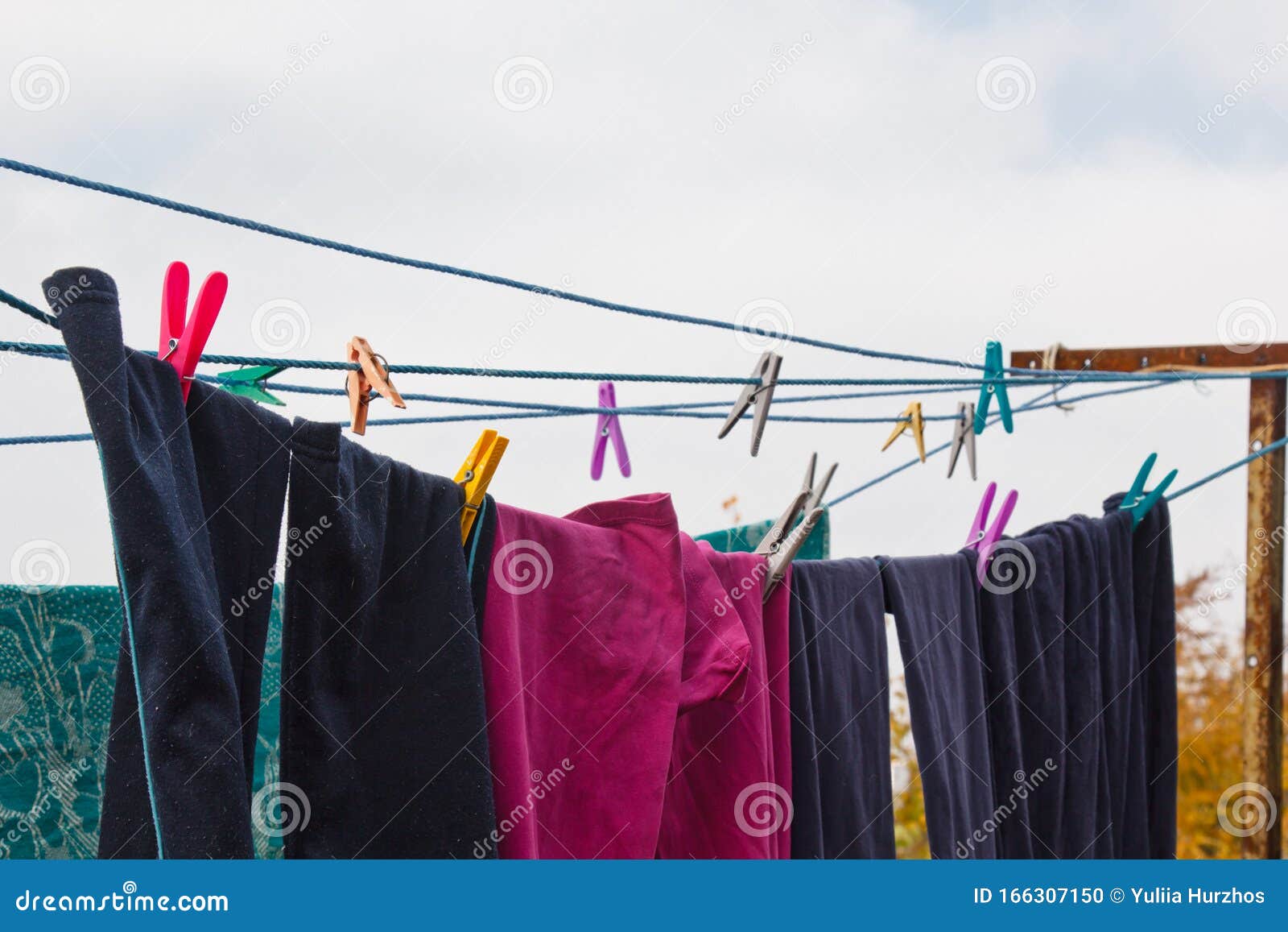 A Clothespin Hangs on the Washing Line. a Rope with Clean Linen