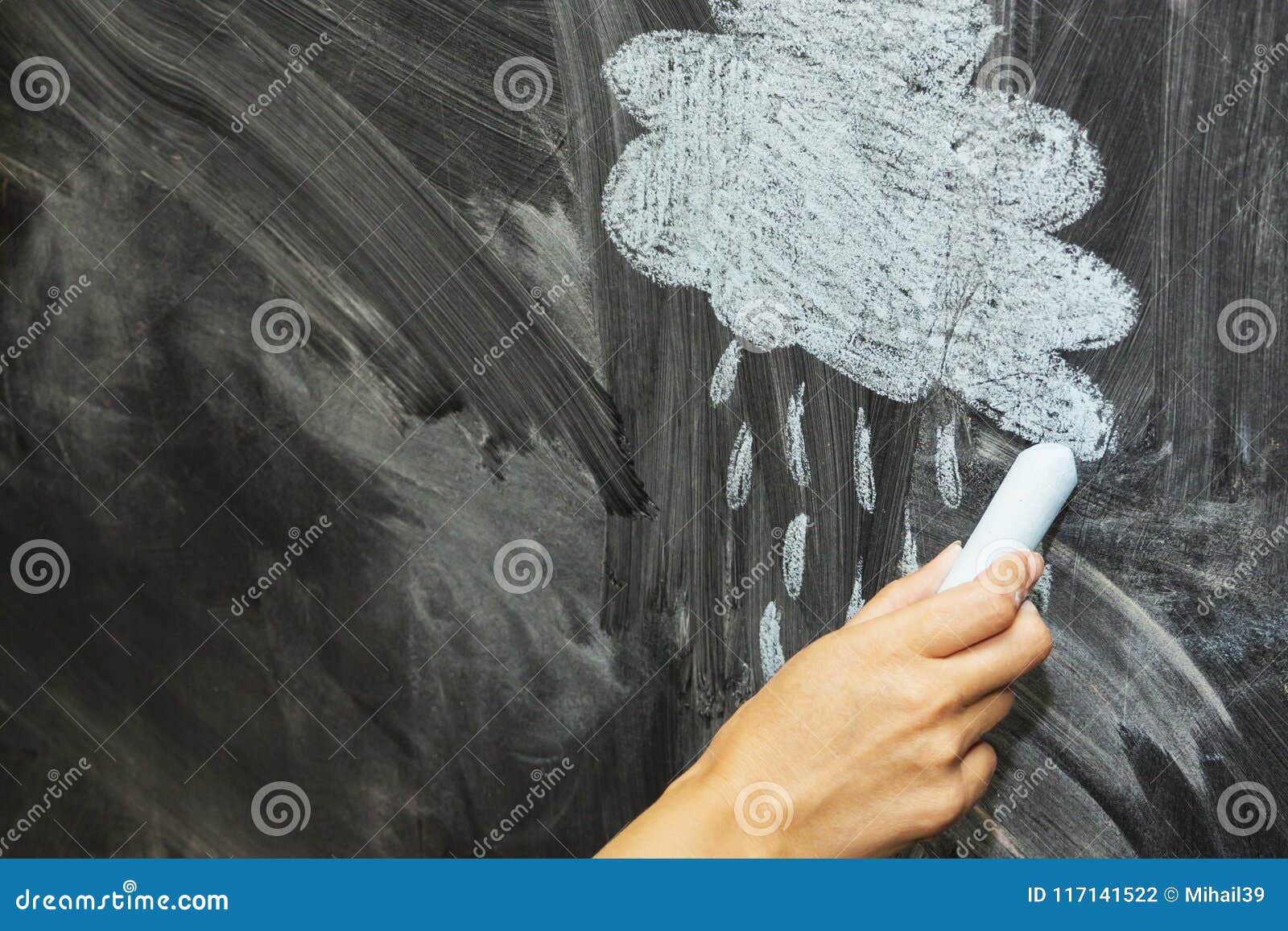 A Cloud and a Rain Drawn with Chalk on a Blackboard. Stock Photo