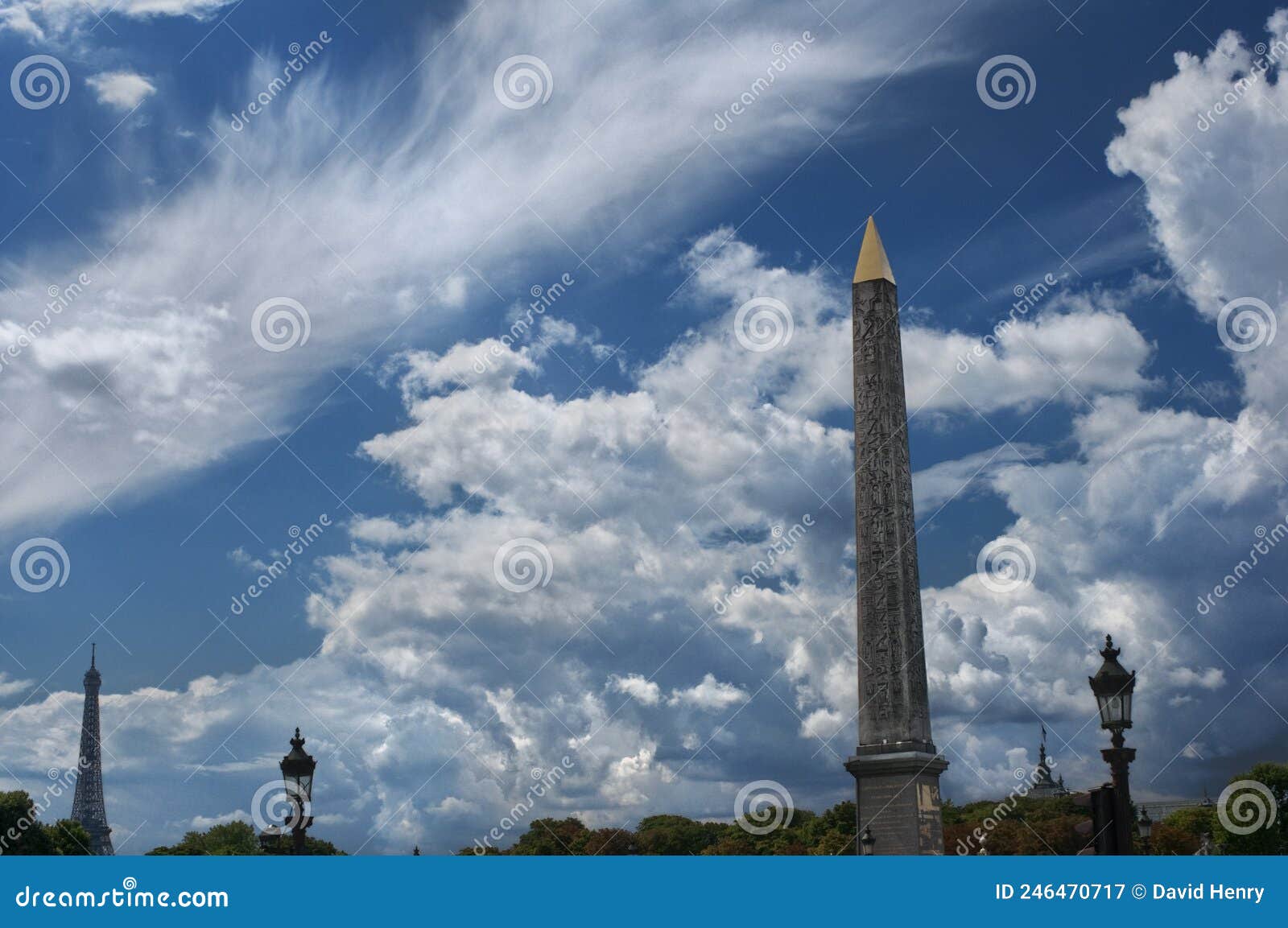 clouds floating behind the obelisk of luxor