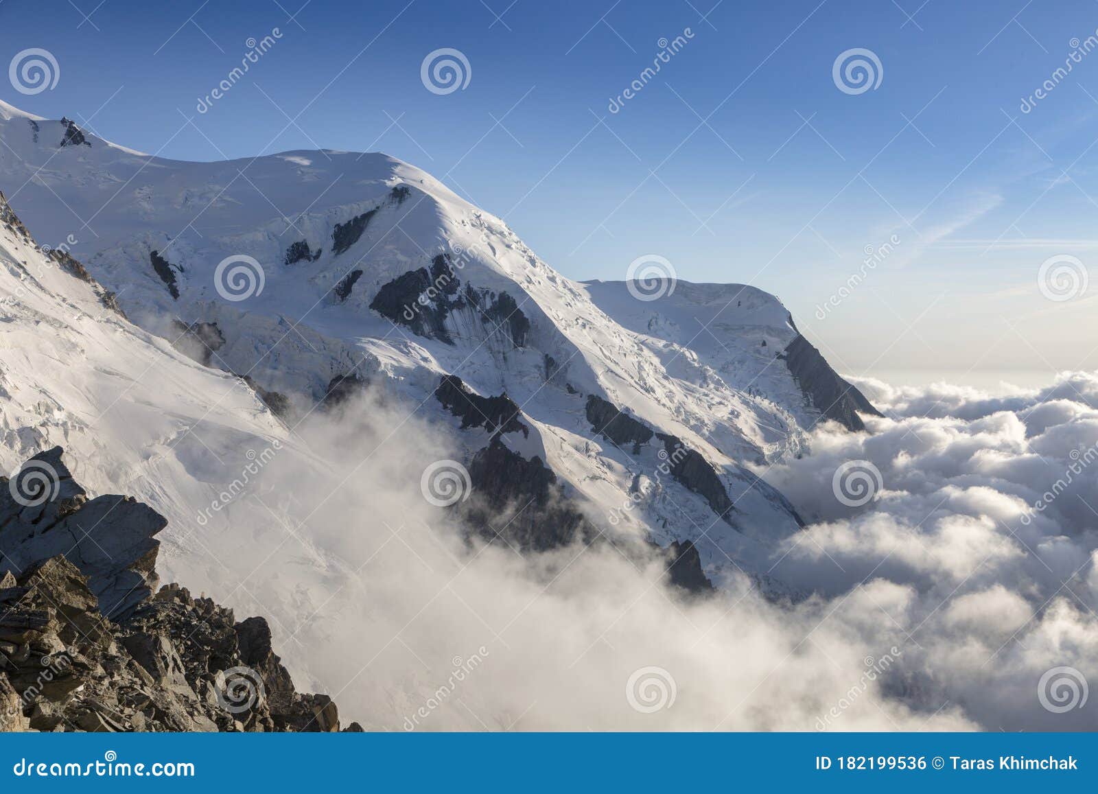 clouds and fog near dome du gouter and bosson glacier mont blanc massif in the french alps. view from the cosmique refuge,