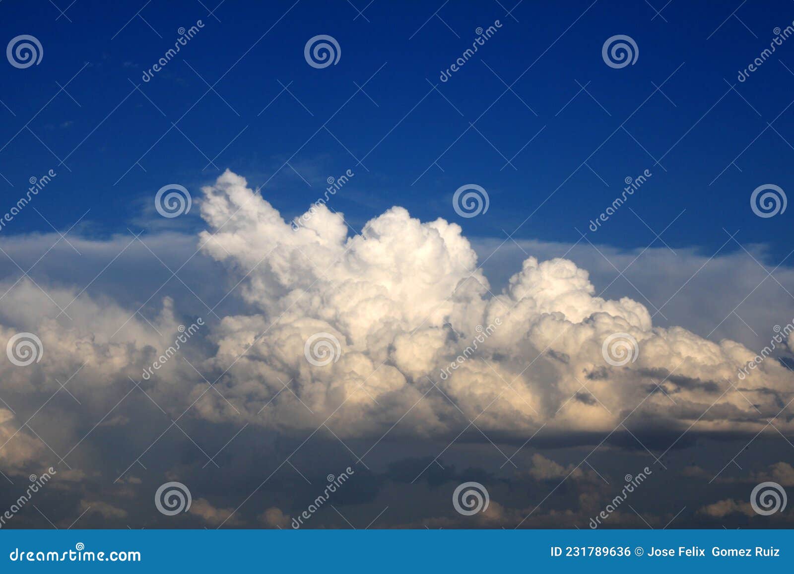 compact clouds over a dark blue sky