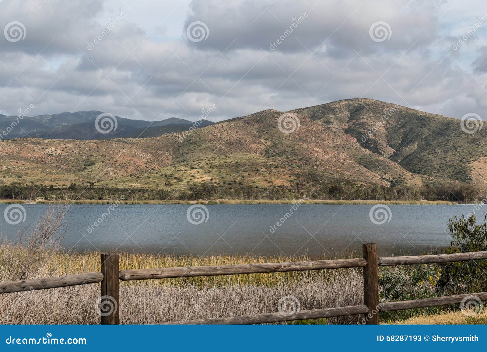 clouds over a mountain range and lake in chula vista, california