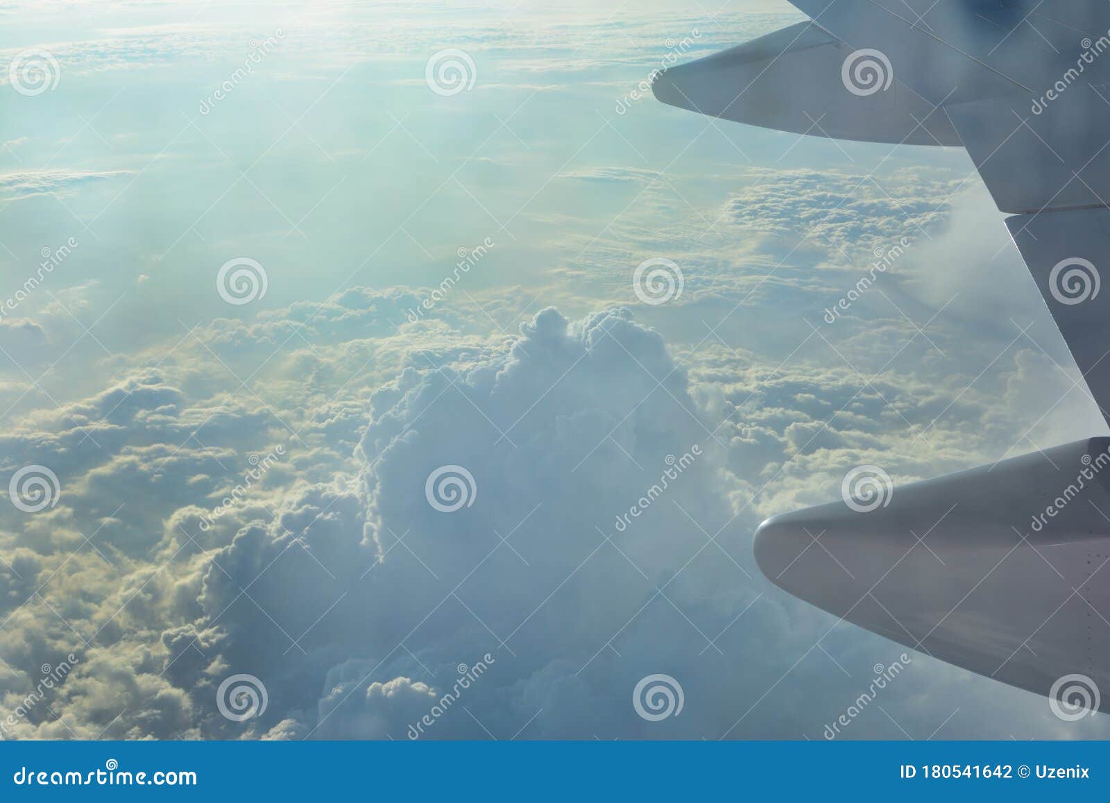 clouds the sky and part of the plane`s wing. during the flight