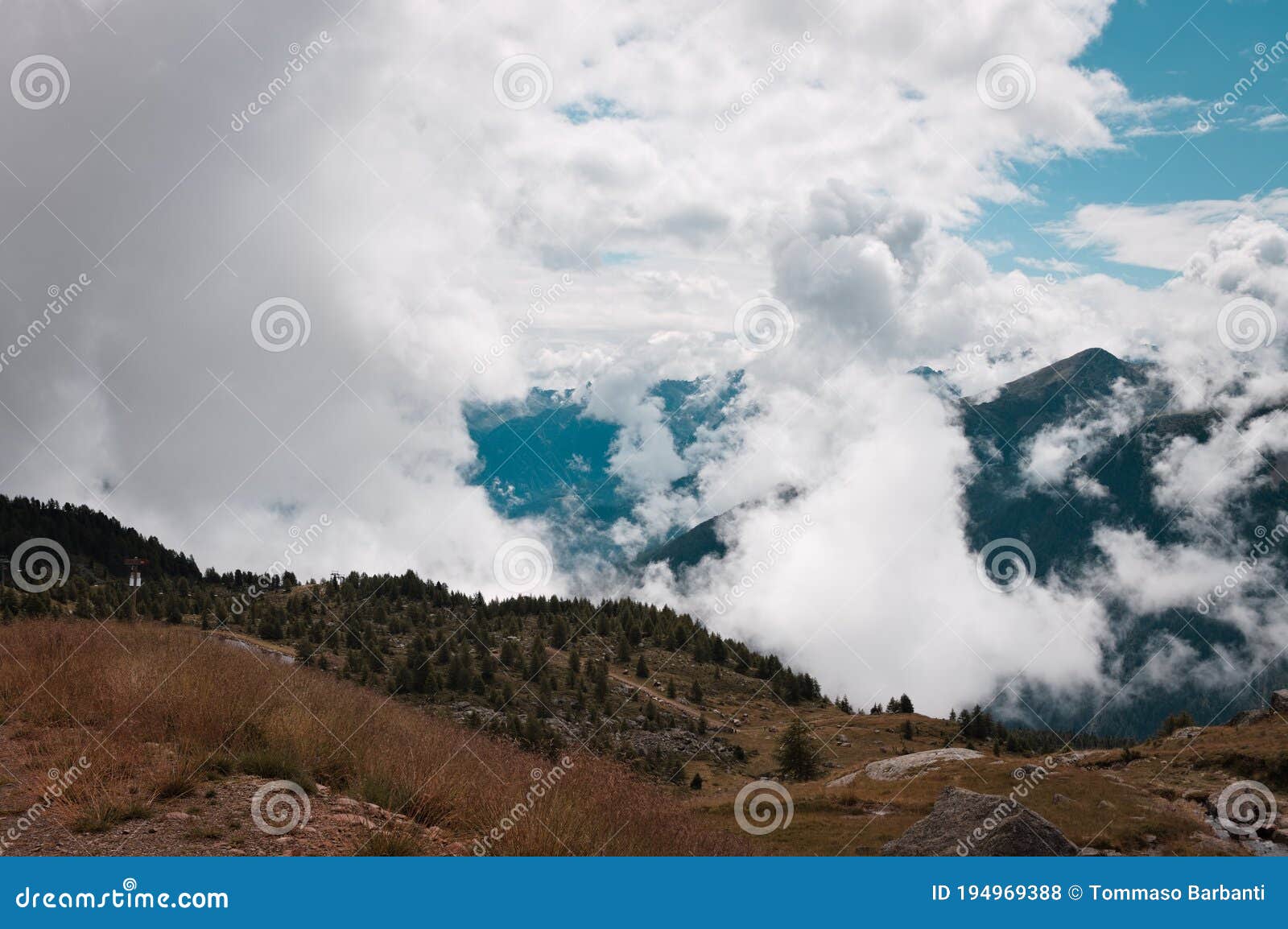 cloudscape in the alps with mountains in background peio, trentino, italy