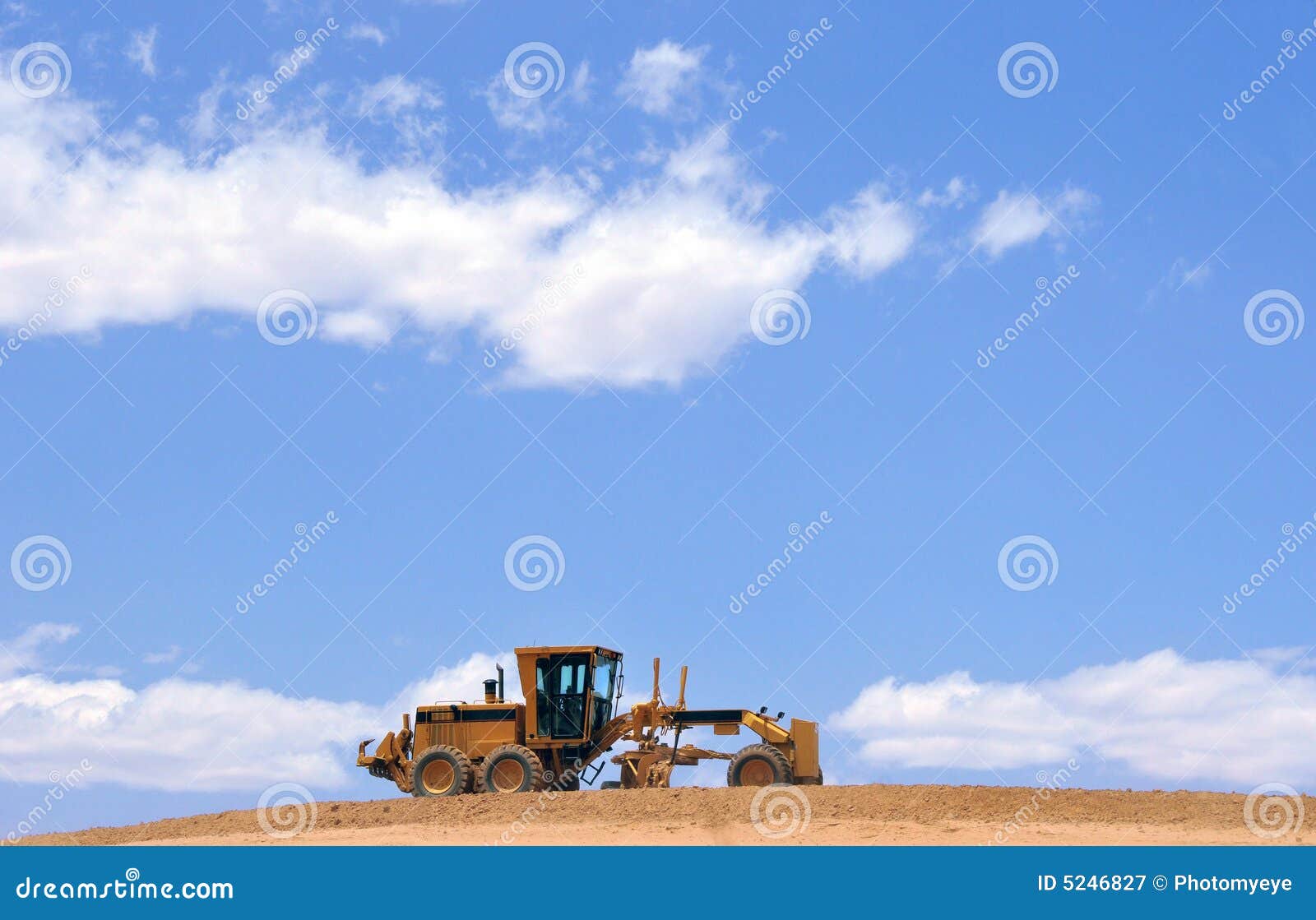 cloudscape and road grader