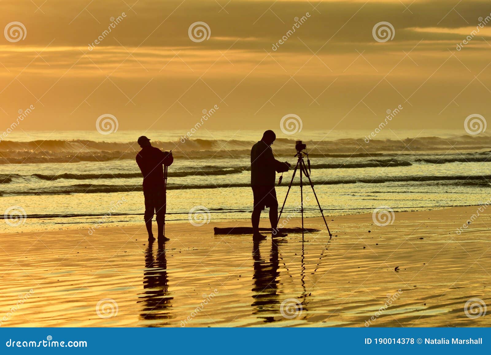 An Unidentified Photographer Taking Photographs Of A Sunset At The Sea