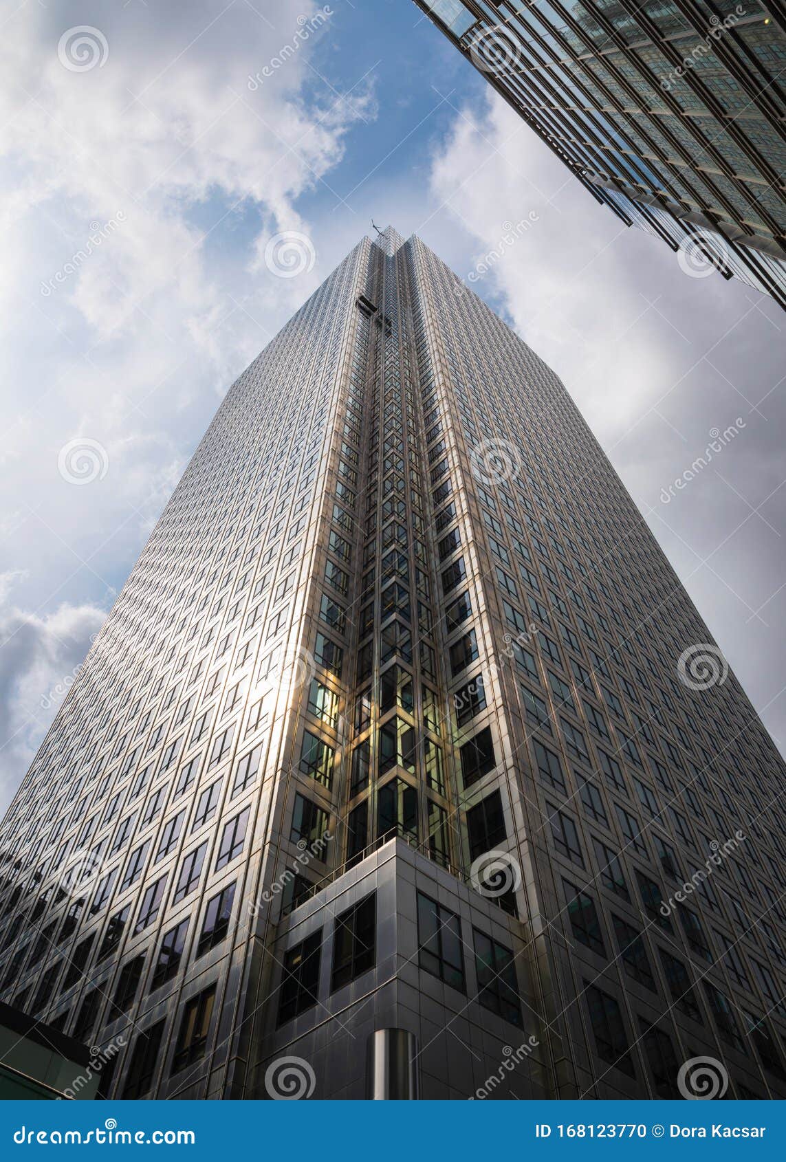 cloudy and sunny sky with a modern building at one canada sqare