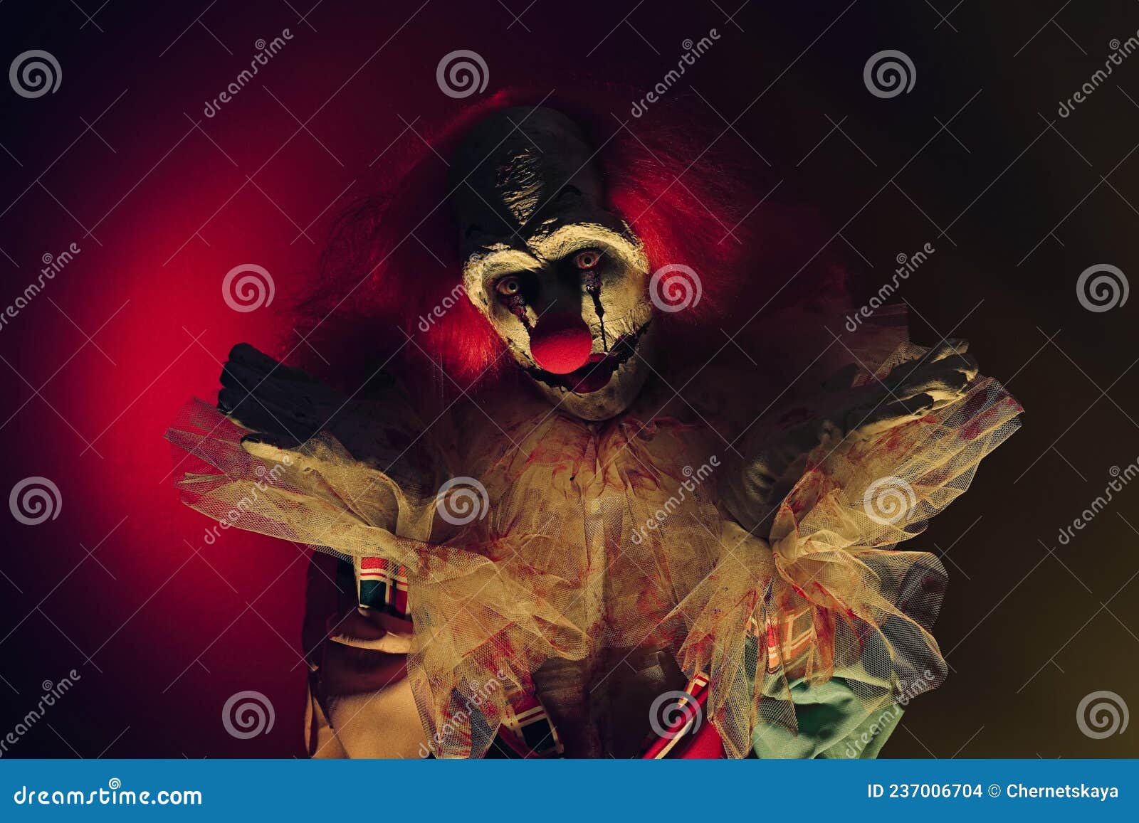 Terrifying Clown in Darkness. Halloween Party Costume Stock Photo