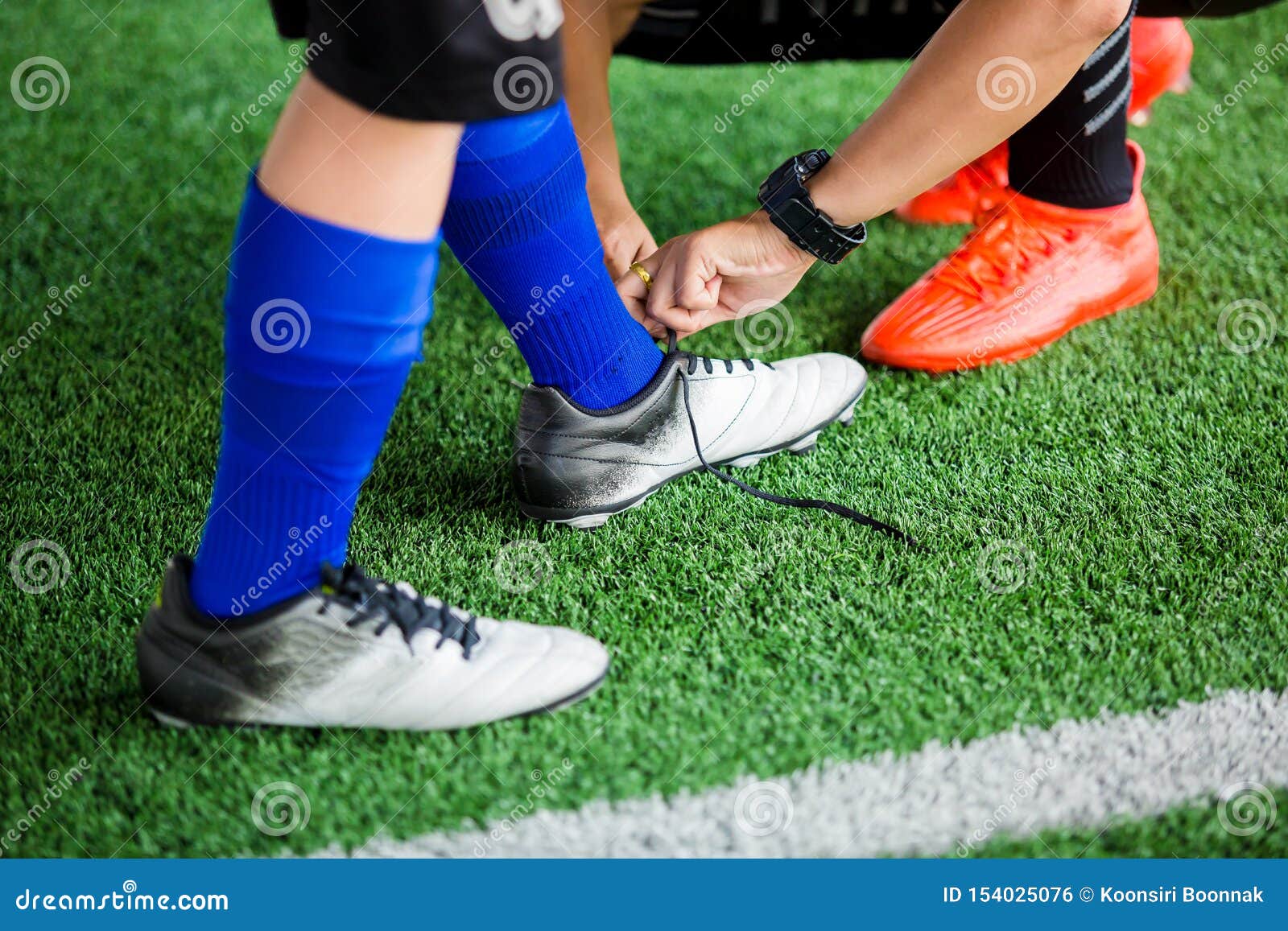 Coach Sitting To Tying Sport Shoelaces 