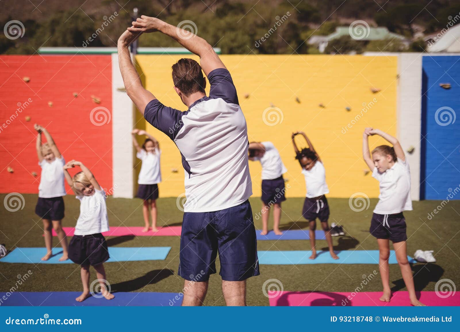 Coach Teaching Exercise To School Kids Stock Photo Image
