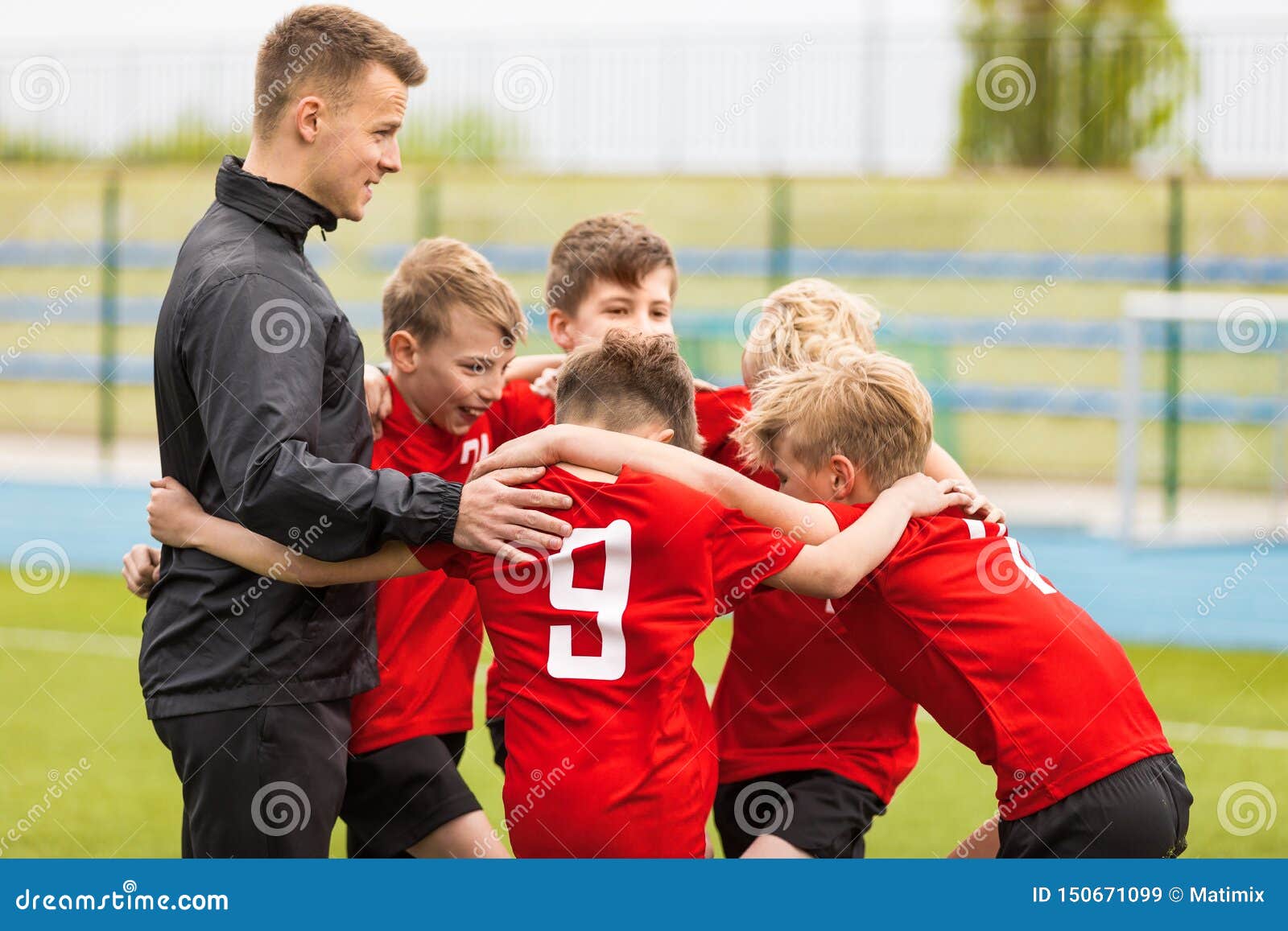 coaching youth sports. kids soccer football team huddle with coach