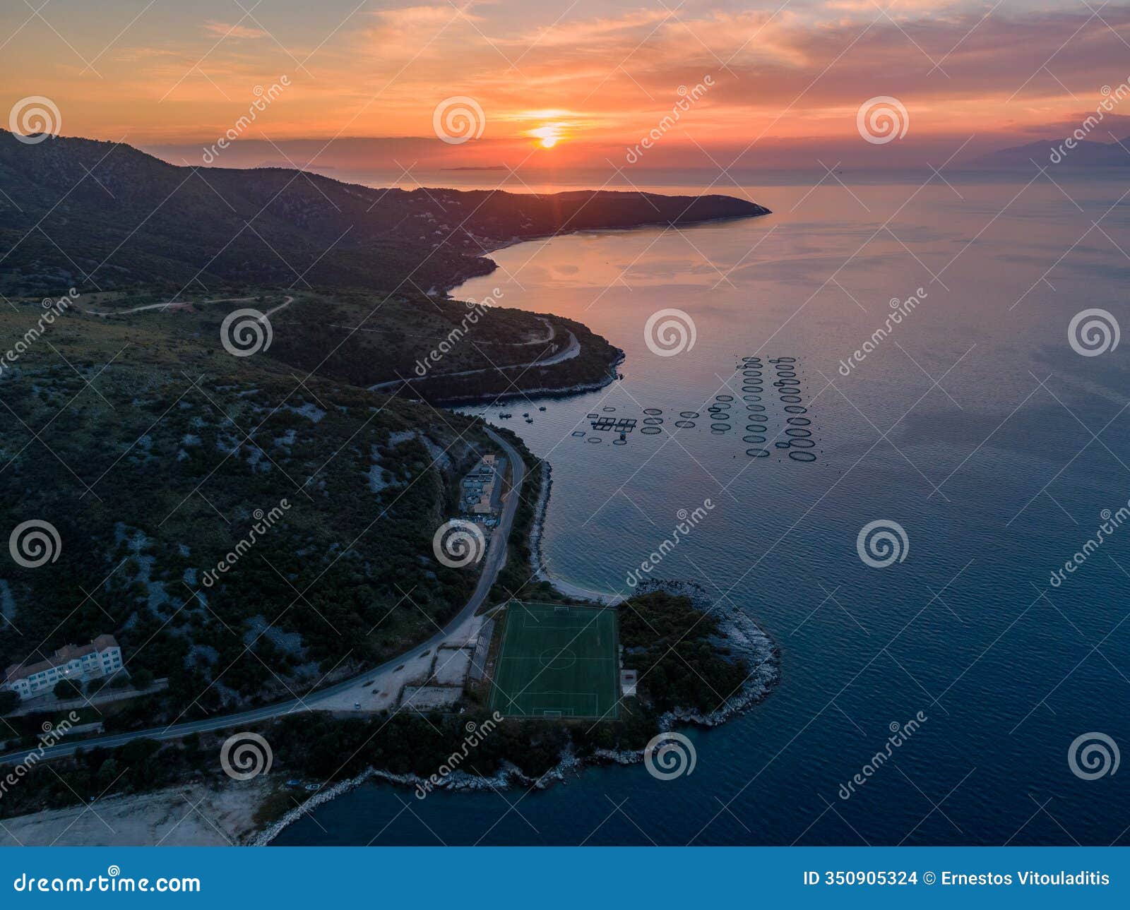 coastal sunset with a unique aquatic structure. serene landscape at golden hour