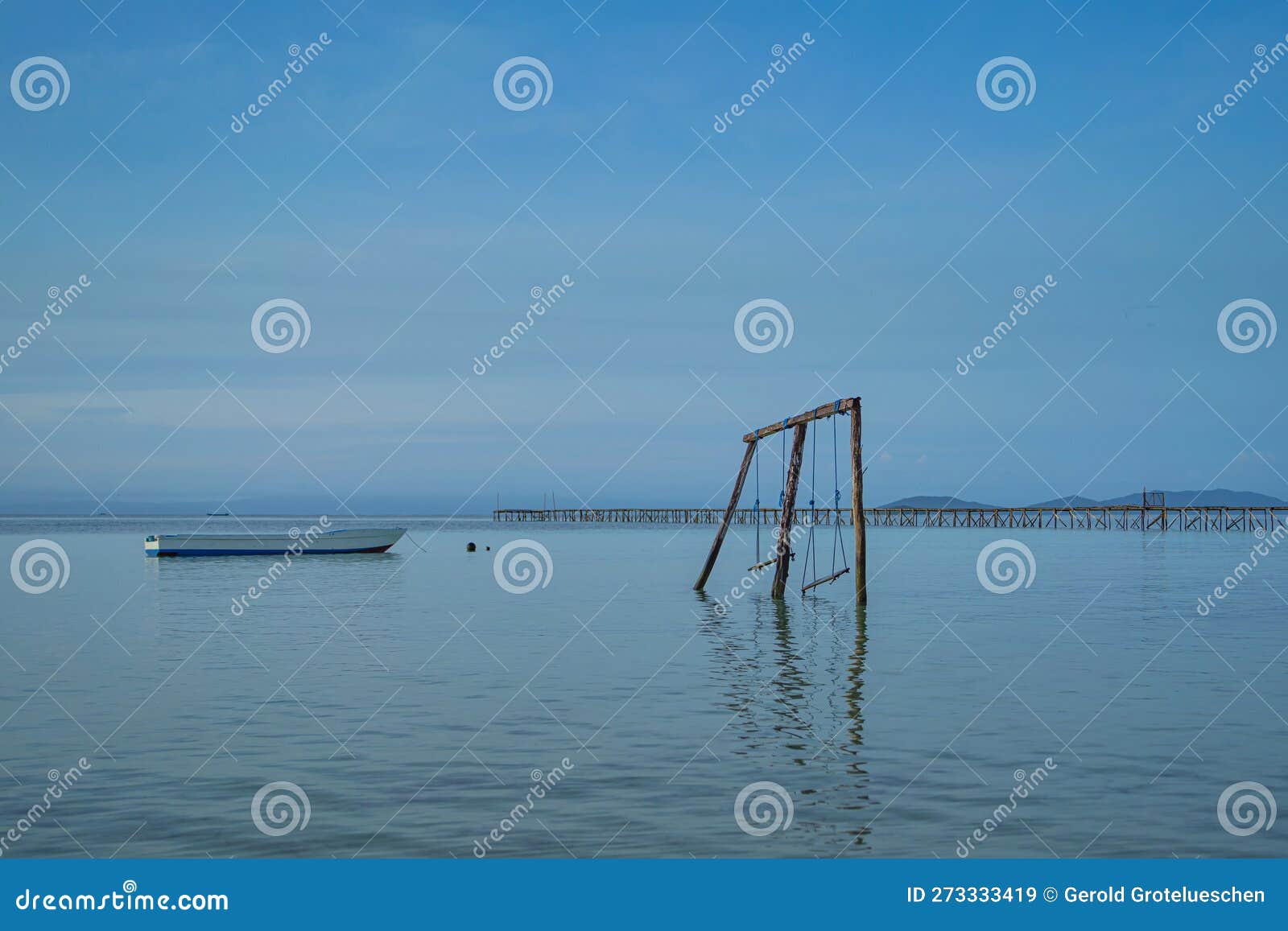 coastline at saporkren on waisai island, raja ampat with a swing over water