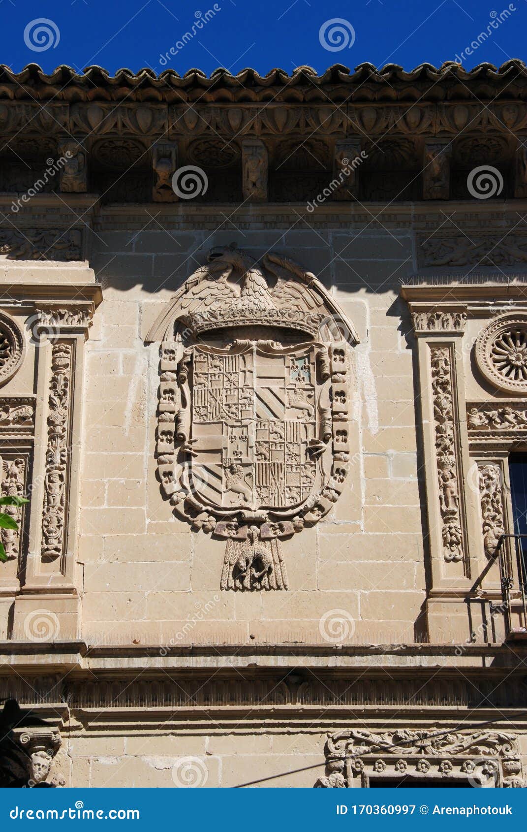 coat of arms on the front town hall along the cardenal benavides street, baeza, spain.
