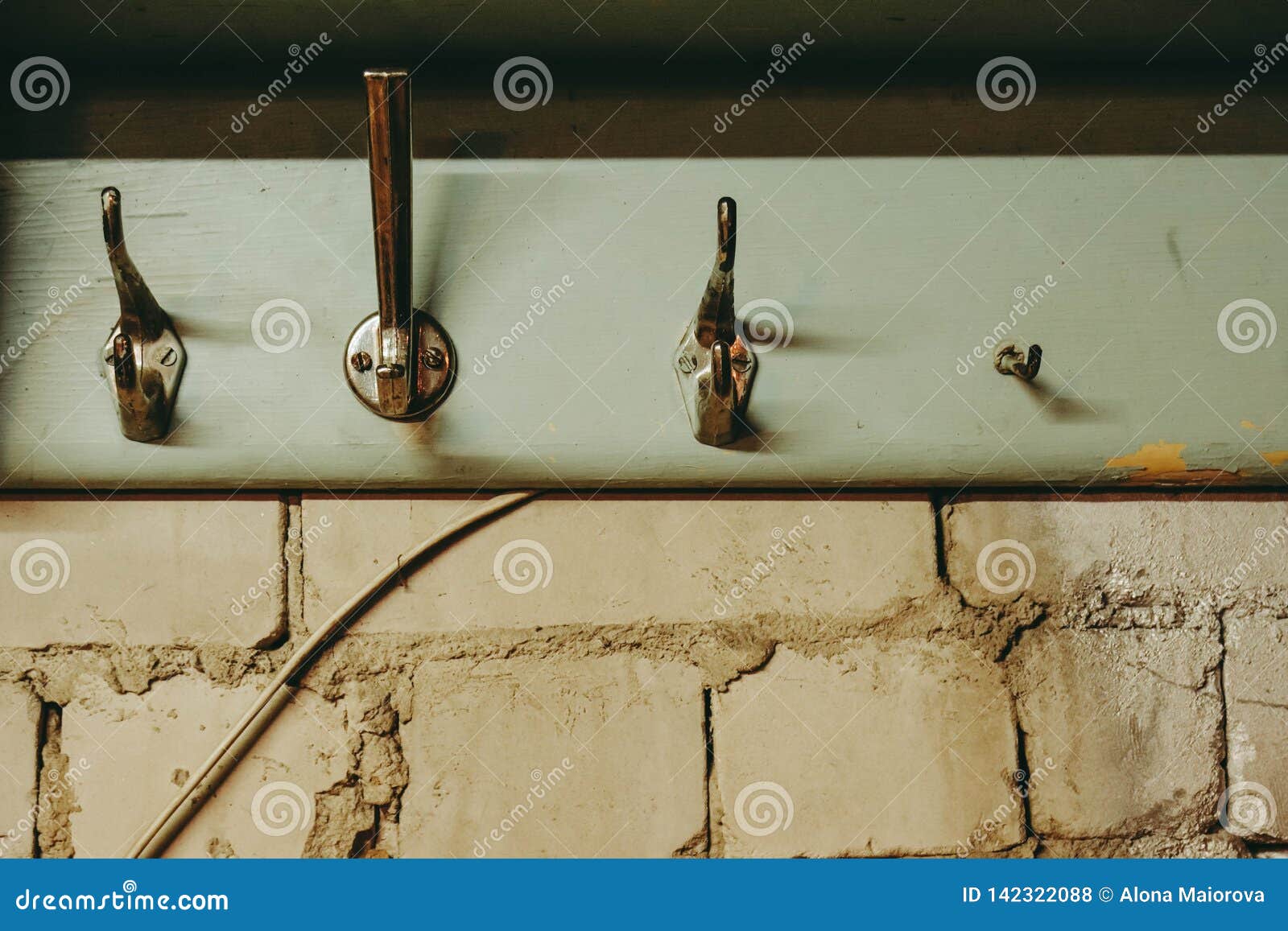 Coat hooks on bricks wall stock photo. Image of coat 142322088