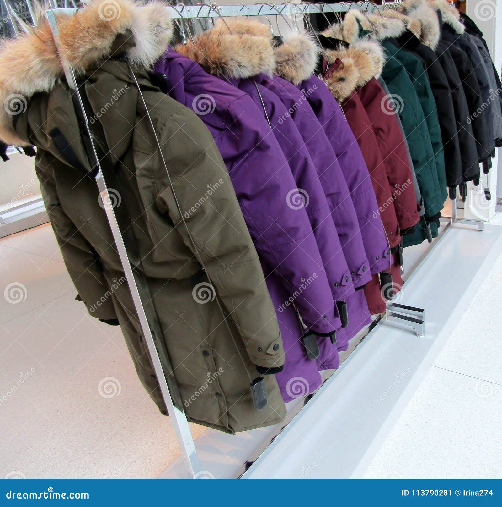 Coats with Fur on Hood Hanging on Clothes Rack Stock Image - Image of ...