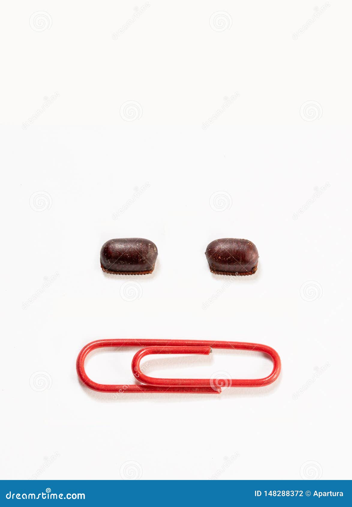 cockroach eggs size relative comparison between paper clip. two cockroach egg capsule and red paper clip