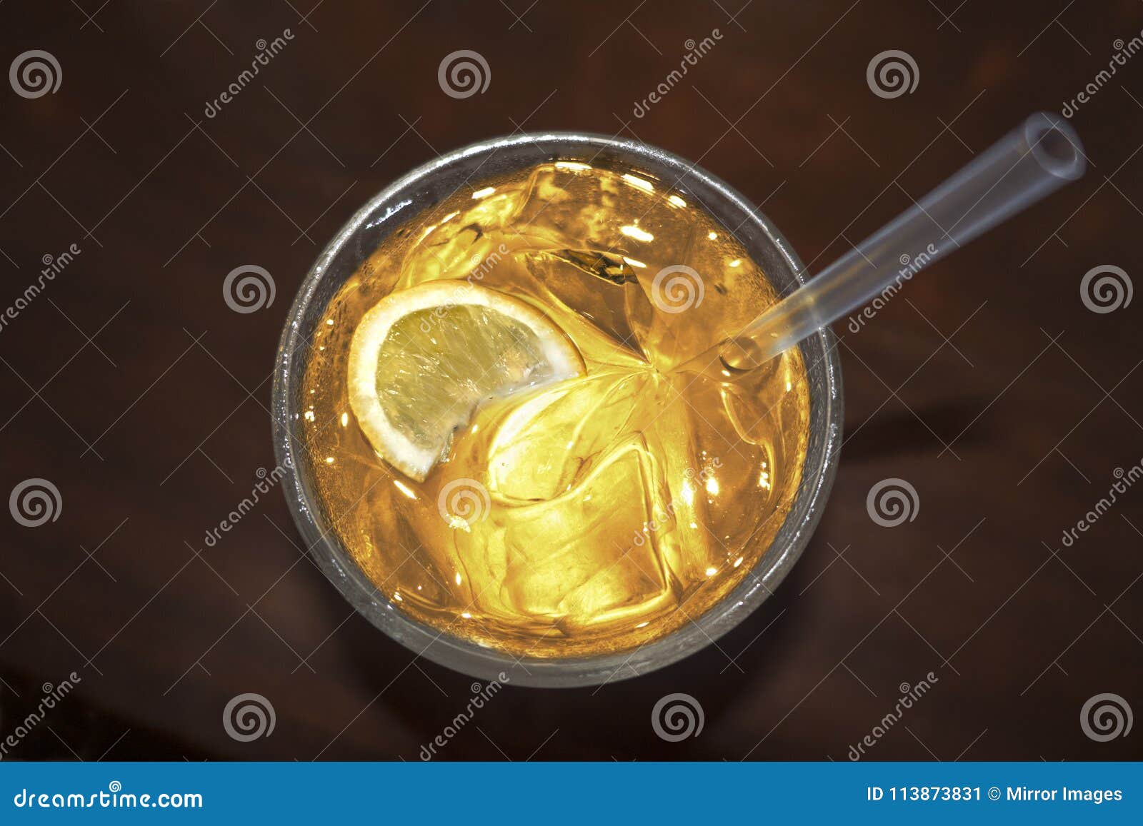 cocktail drink with lemon silice golden yellow liquid