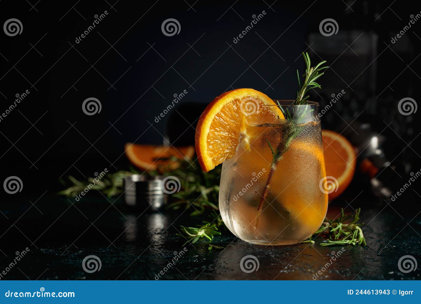 cocktail gin tonic with ice, orange, and rosemary