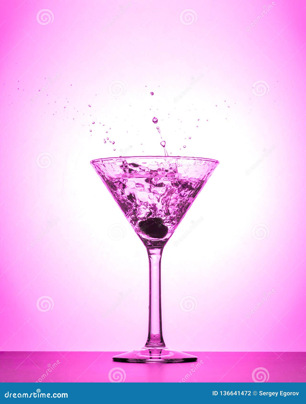 Cocktail Martini Glass Splash On White And Pink Gradient Background
