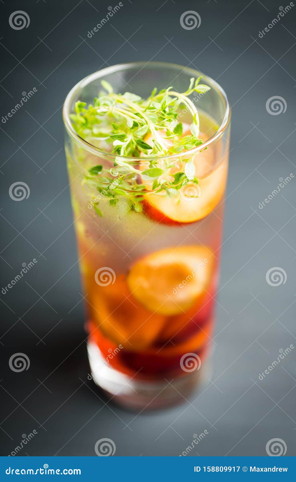 Cocktail with Plums and Thyme on the Rustic Background Stock Image