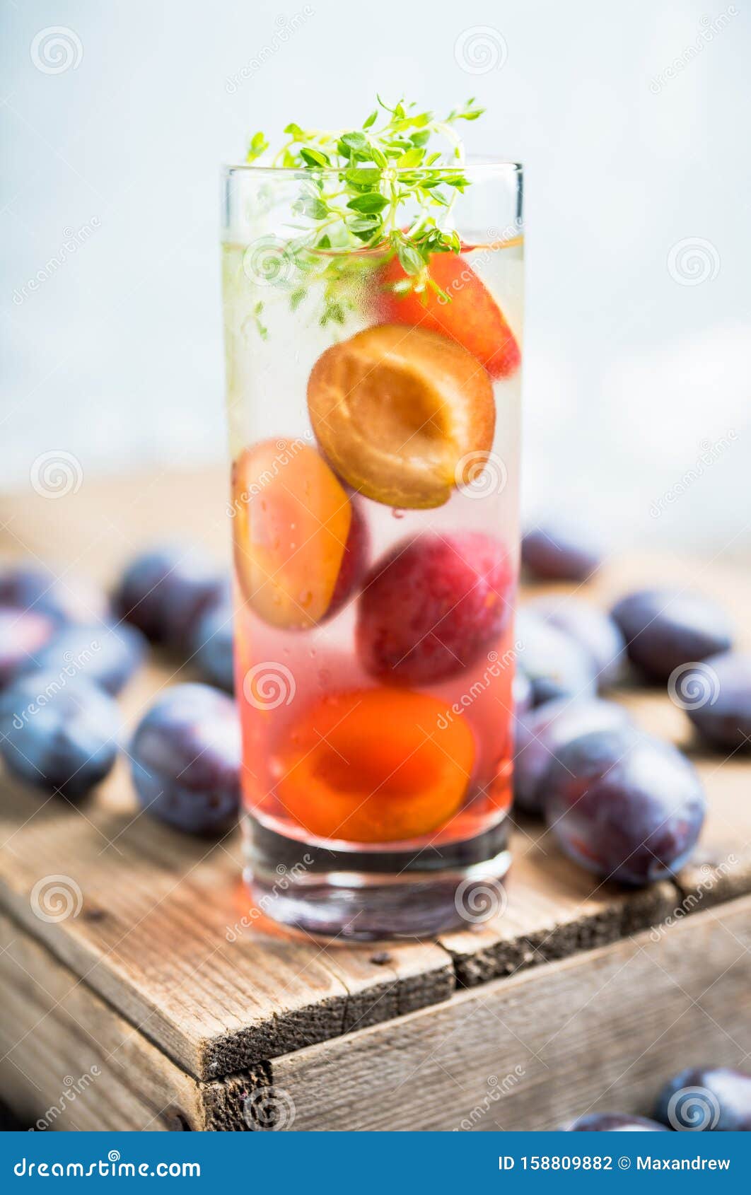 Cocktail with Plums and Thyme on the Rustic Background Stock Photo
