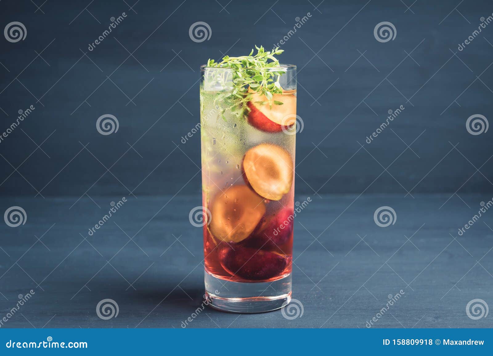 Cocktail with Plums and Thyme on the Rustic Background Stock Photo