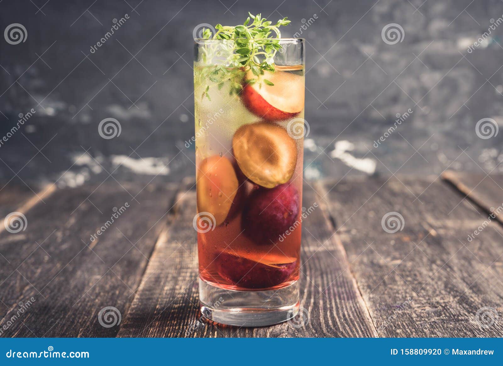 Cocktail with Plums and Thyme on the Rustic Background Stock Photo