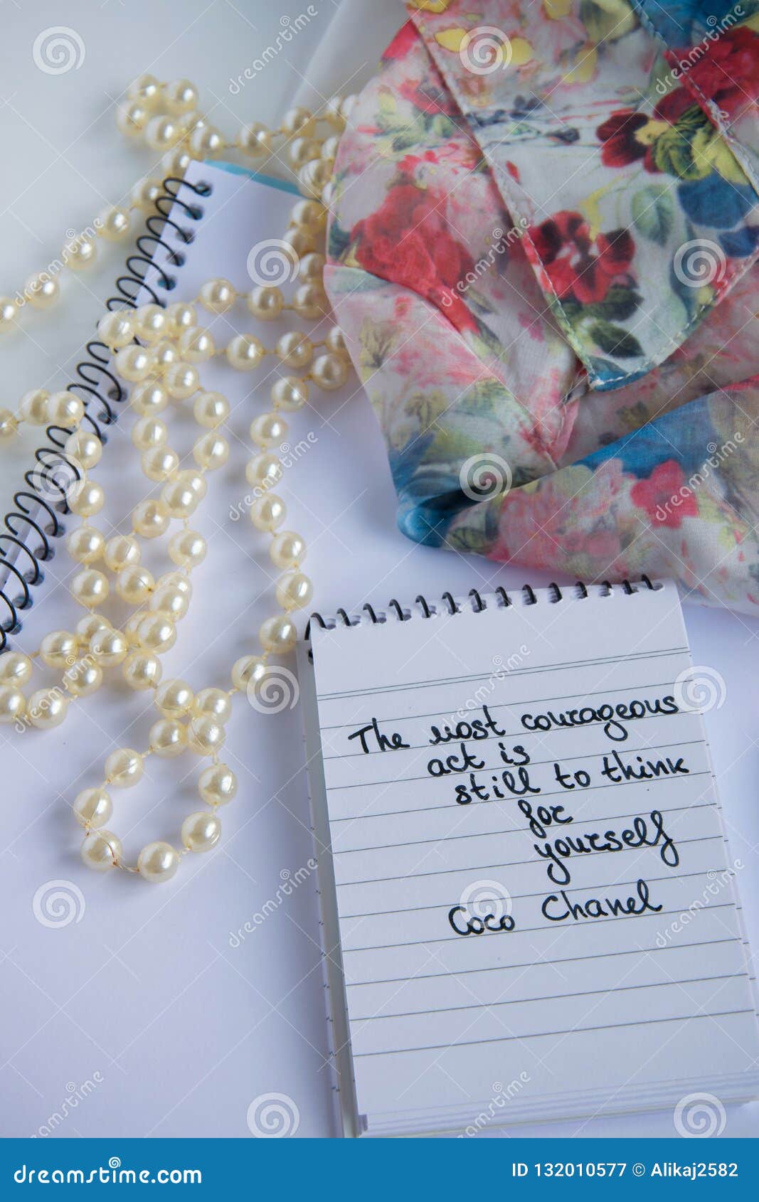 Coco Chanel quotes written on a block note, pearl accessories and a classy  jacket ,inspiration phrase A girl should be two things: classy and fabulou  Stock Photo - Alamy