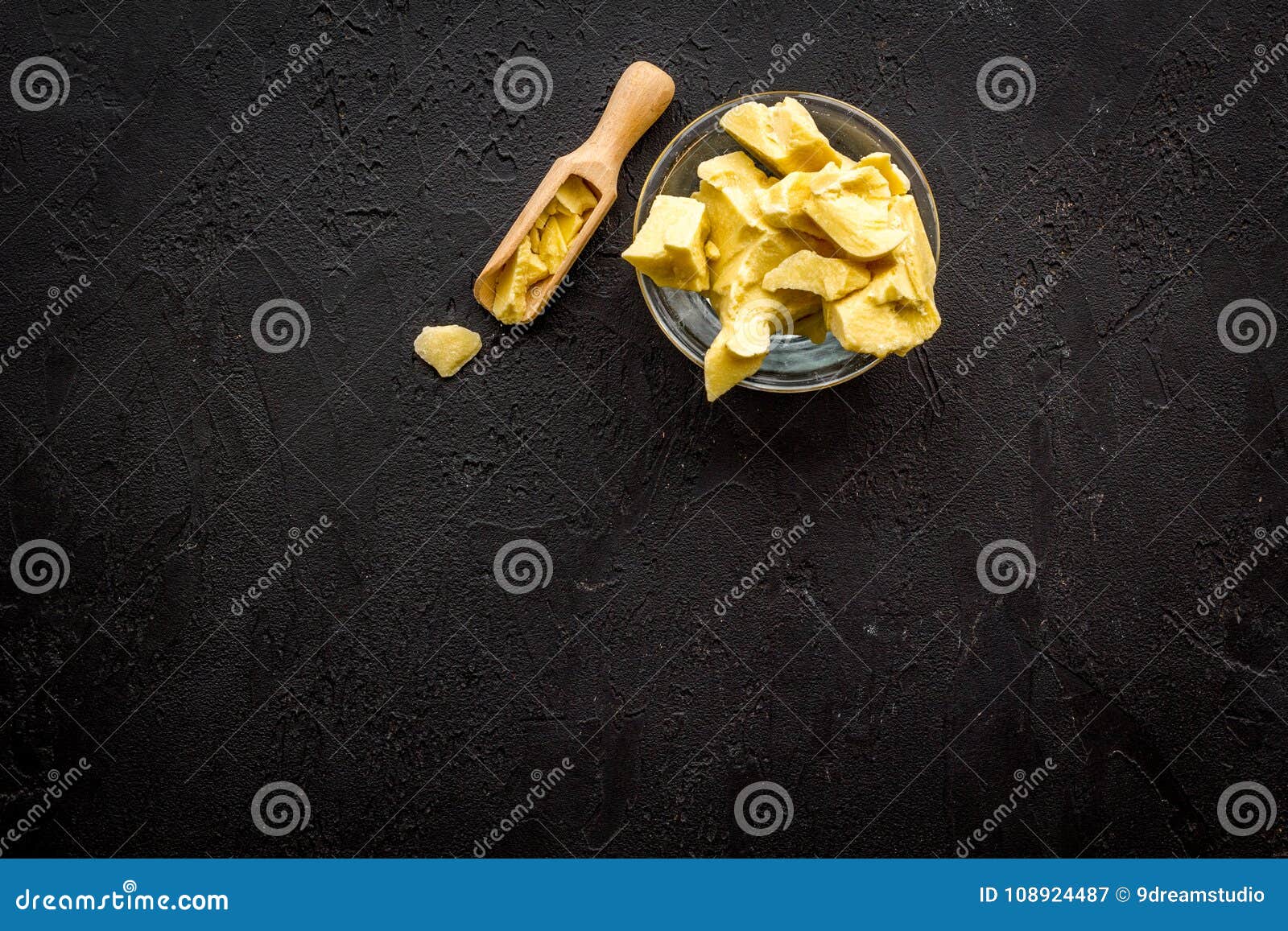 cocoa butter for homemade cosmetics. black background top view copy space