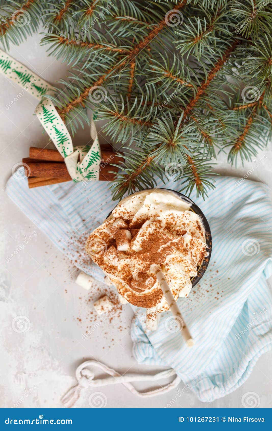 cocoa with cream and cinnamon on a concrete background