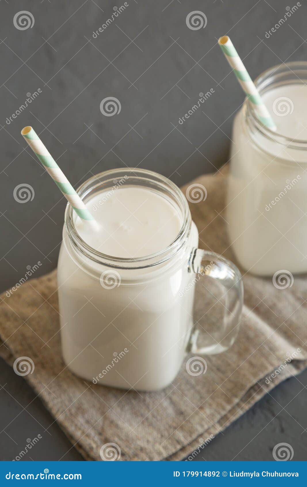 Coconut Milk in Glass Jars, Low Angle View. Closeup Stock Photo
