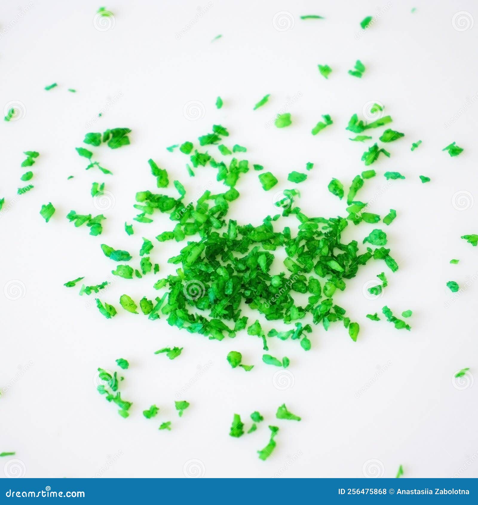 Coconut Shavings Painted Green on a White Background. Flat Lay, Top