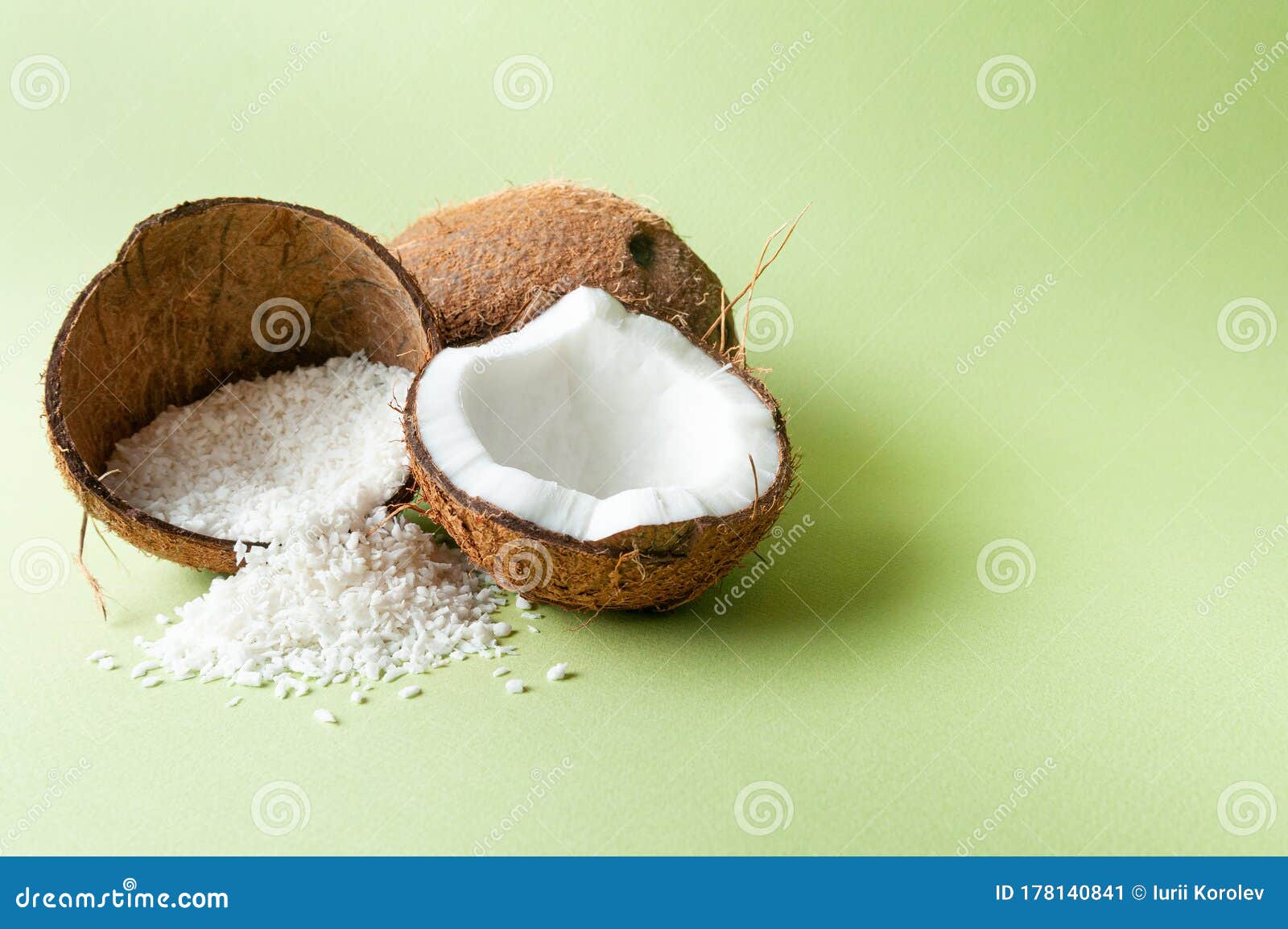 Coconuts Whole and Halved. Coconut Flakes are Poured into the Coconut
