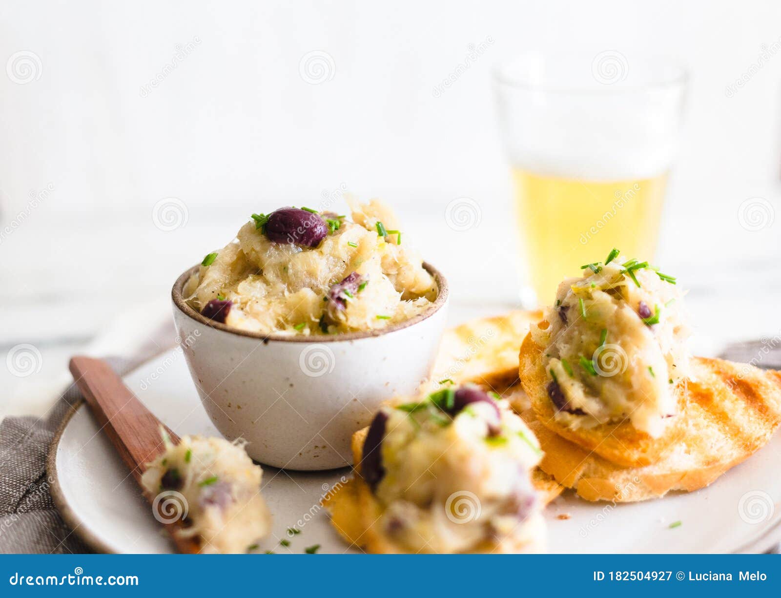 Cod Fish Brandade on a White Ceramic and Rustic Napkin Stock Image