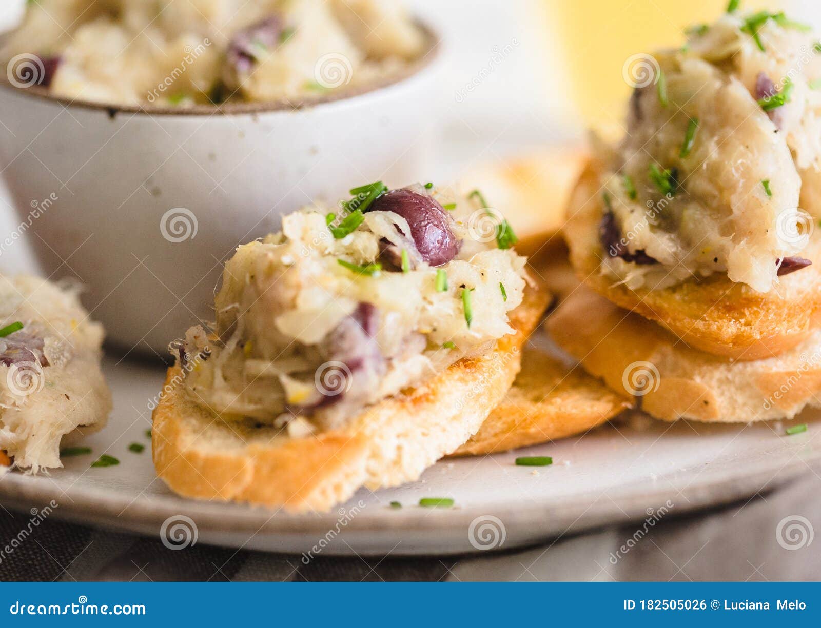 Cod Fish Brandade on a White Ceramic and Rustic Napkin Stock Photo