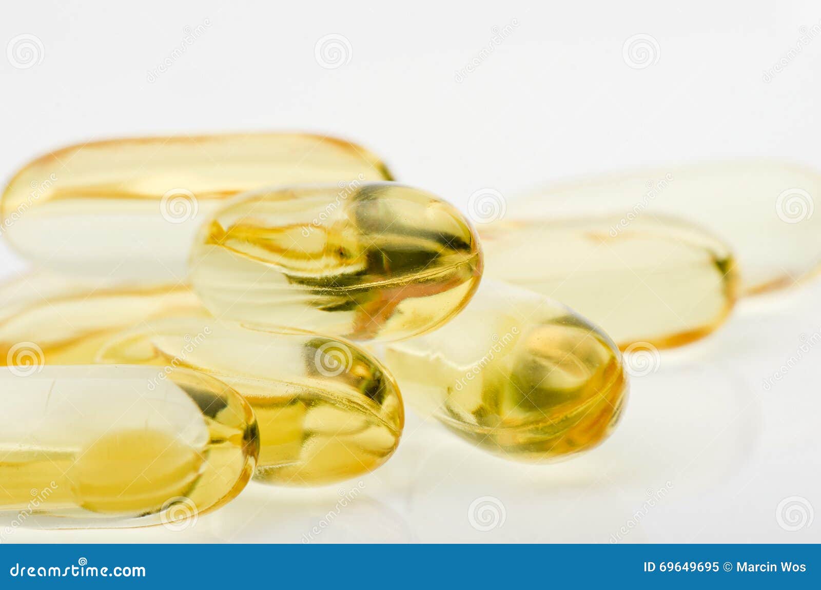 Cod Liver Vitamin D Capsules on White Reflective Surface Stock Image