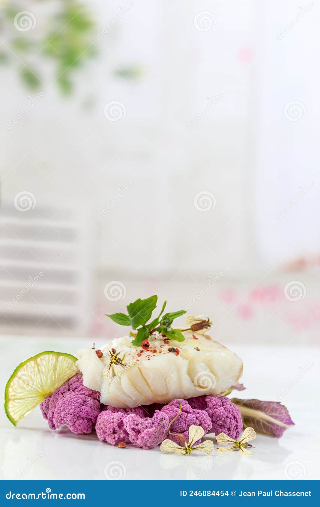 cod steak steam with purple coliflower on lightbackground
