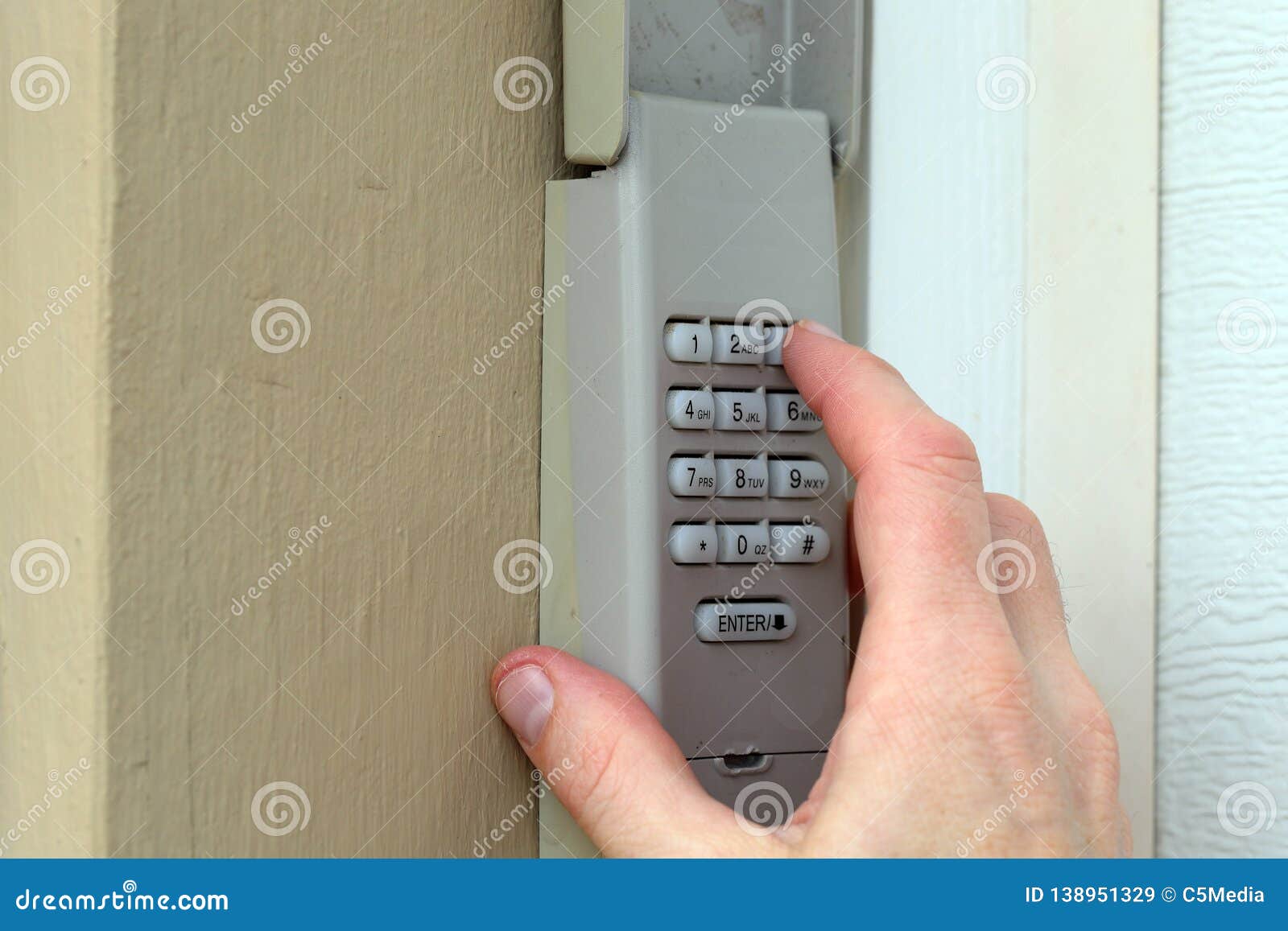 Hand Entering Code On Keypad Garage Door Opener Home