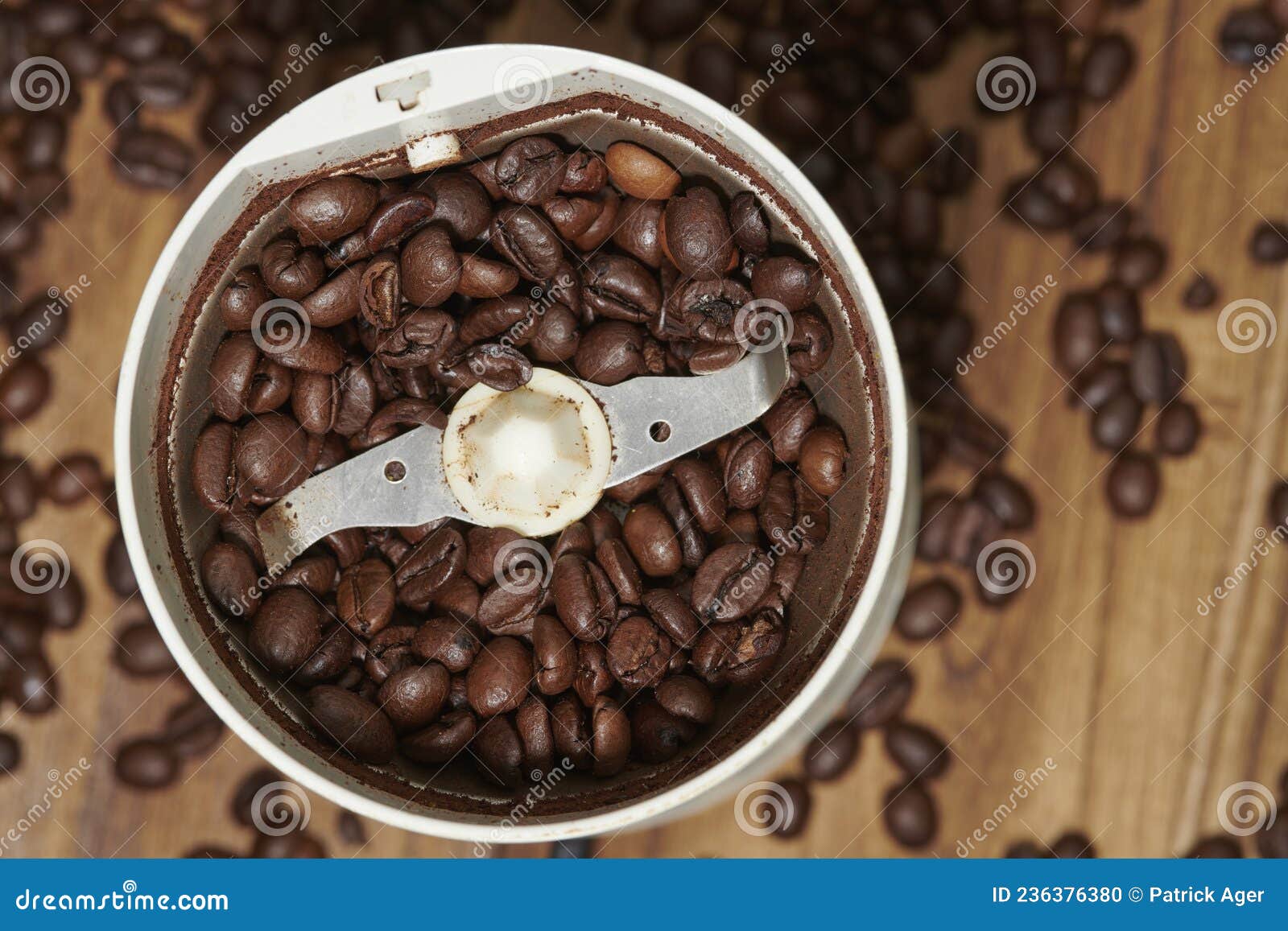 coffee beans and grinder on zebrano wood table top